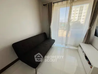 Bright living room with modern sofa and large window offering city view