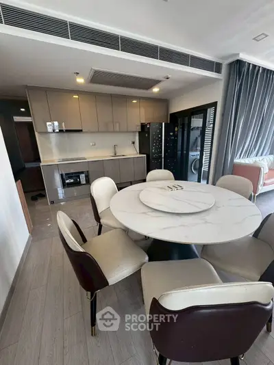 Modern kitchen with sleek cabinets and elegant dining area