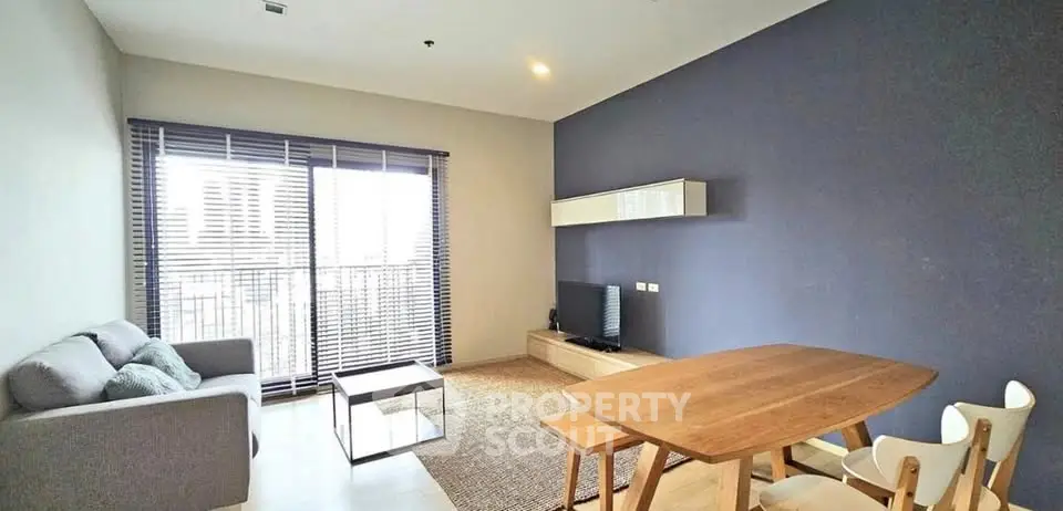 Modern living room with stylish furniture and large window for natural light.