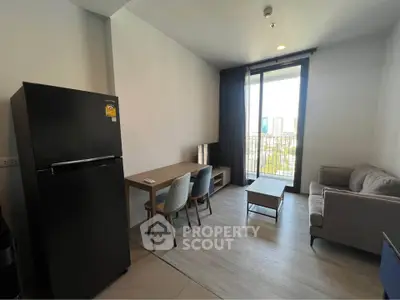 Modern living room with balcony view, featuring sleek furniture and a spacious layout.