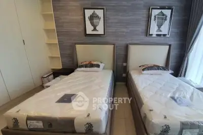 Modern twin bedroom with stylish decor and ample natural light