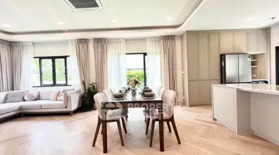 Spacious modern living room with elegant dining area and open kitchen layout.