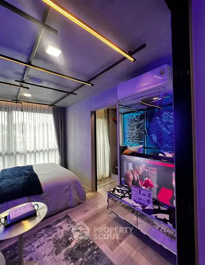 Modern bedroom with stylish lighting and entertainment setup
