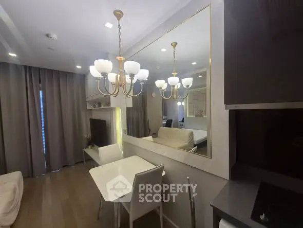 Modern living room with elegant chandelier and cozy dining area