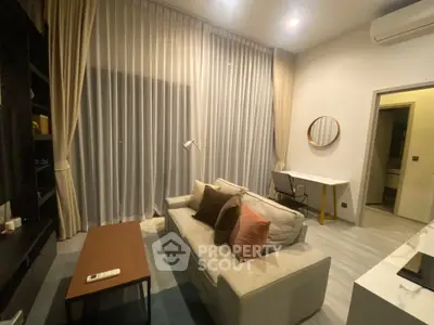 Modern living room with cozy sofa, stylish decor, and elegant lighting