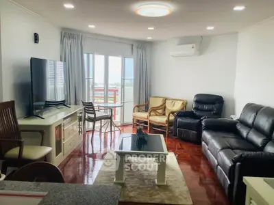 Spacious living room with modern furniture and large windows offering natural light.