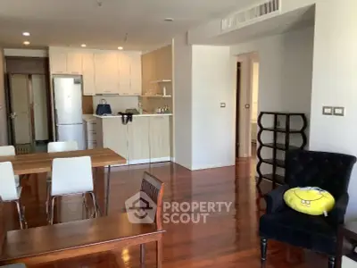 Spacious open-plan living room with modern kitchen and wooden flooring