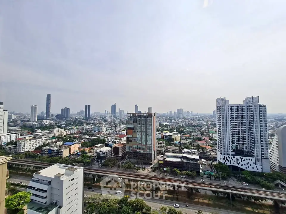 Stunning cityscape view from high-rise apartment showcasing urban skyline and modern architecture.