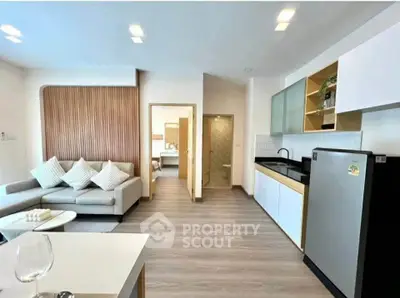 Modern open-layout living room with sleek kitchen and stylish decor