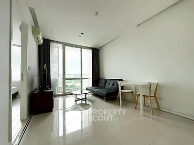 Modern living room with sleek furniture and large windows offering stunning city views.