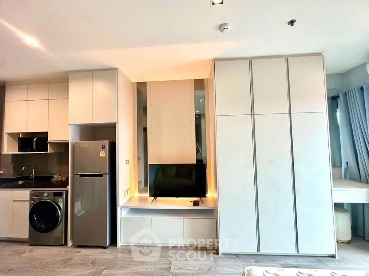 Modern apartment interior with sleek kitchen and integrated appliances