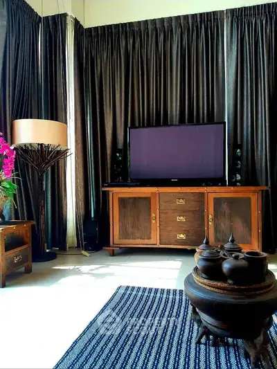 Elegant living room with vintage wooden furniture and modern TV setup