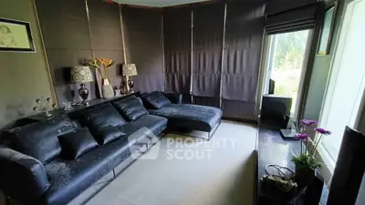 Stylish living room with black leather sofa and modern decor