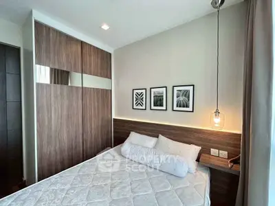 Modern bedroom with stylish decor and built-in wardrobe in a cozy apartment.