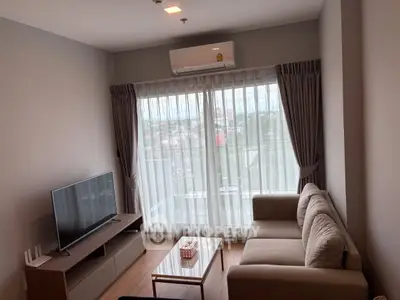 Modern living room with large window and stylish furniture in a cozy apartment.