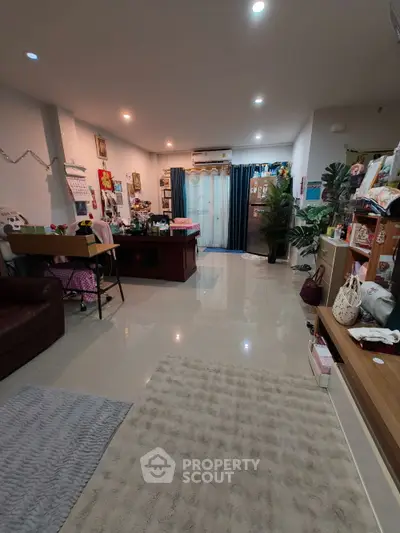 Spacious living room with modern decor and ample natural light, perfect for family gatherings.
