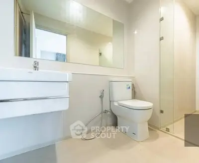 Modern bathroom with sleek fixtures and glass shower enclosure