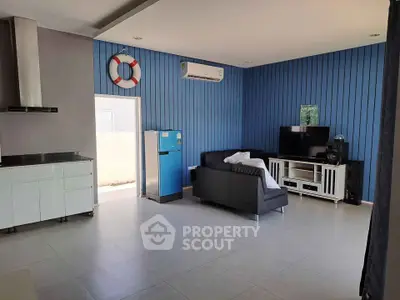 Modern living room with sleek design, featuring a TV, sofa, and air conditioning.