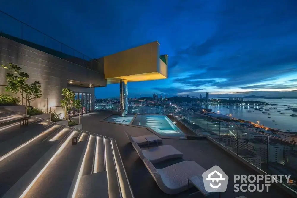 Luxurious rooftop with stunning city and ocean views, featuring modern design and illuminated steps.