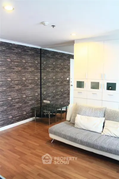 Modern living room with stylish brick accent wall and cozy sofa