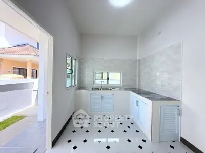 Bright kitchen with modern design and open layout, featuring sleek countertops and ample natural light.