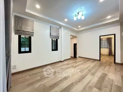 Spacious modern living room with elegant lighting and wooden flooring
