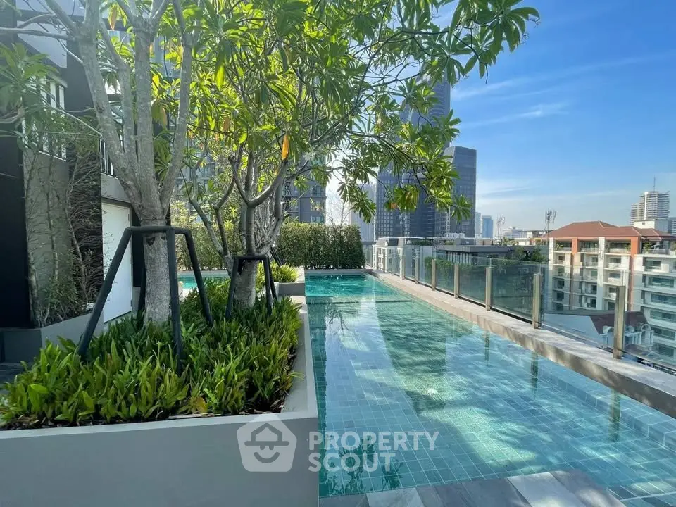 Stunning rooftop pool with city skyline views and lush greenery