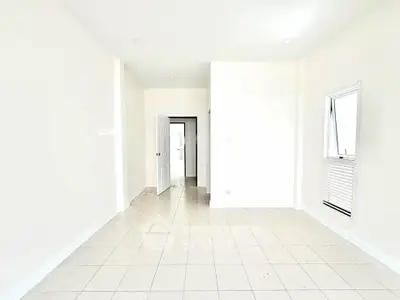 Bright and spacious interior with tiled flooring and open layout, perfect for modern living.