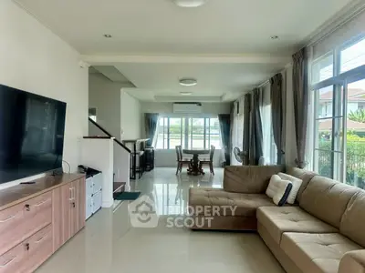 Spacious living room with modern decor and large windows offering natural light.