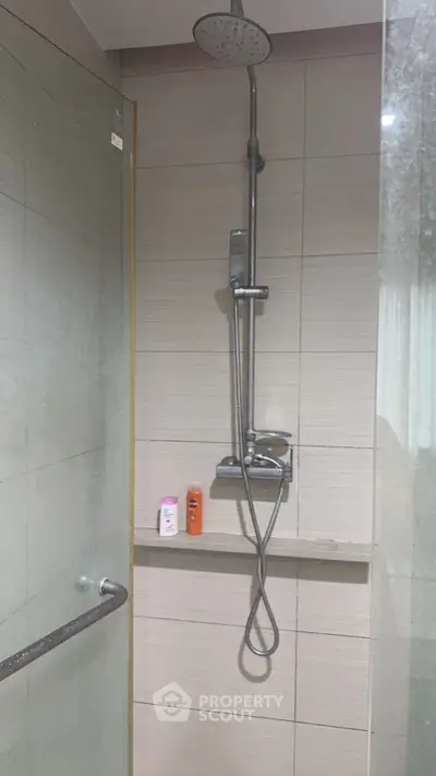 Modern bathroom with sleek shower fixtures and glass door, perfect for a contemporary home.