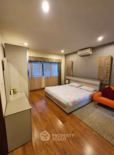 Spacious bedroom with modern decor and cozy ambiance