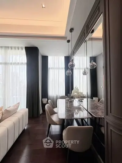 Luxurious modern living room with elegant dining area and floor-to-ceiling windows.