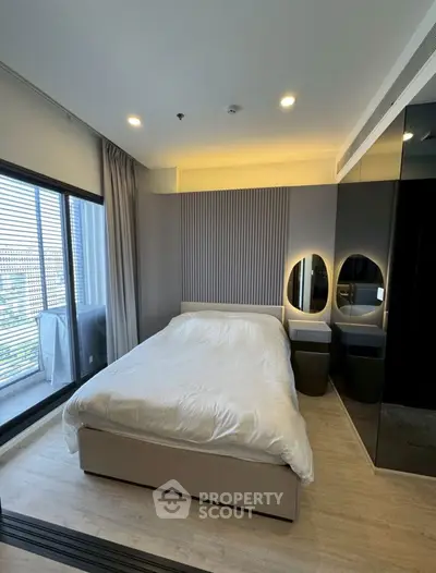 Modern bedroom with sleek design and large window for natural light