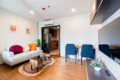 Modern living room with stylish decor and open kitchen layout, perfect for urban living.