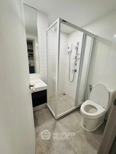Modern bathroom with glass shower enclosure and sleek fixtures