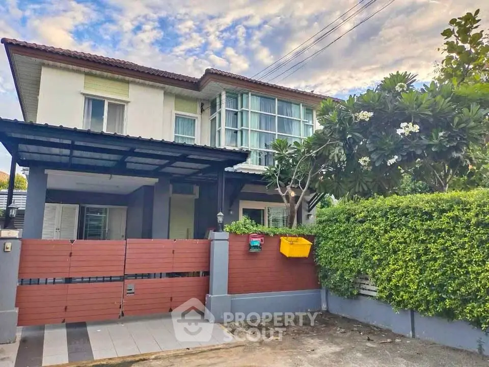 Charming two-story house with lush garden and modern design in a serene neighborhood.