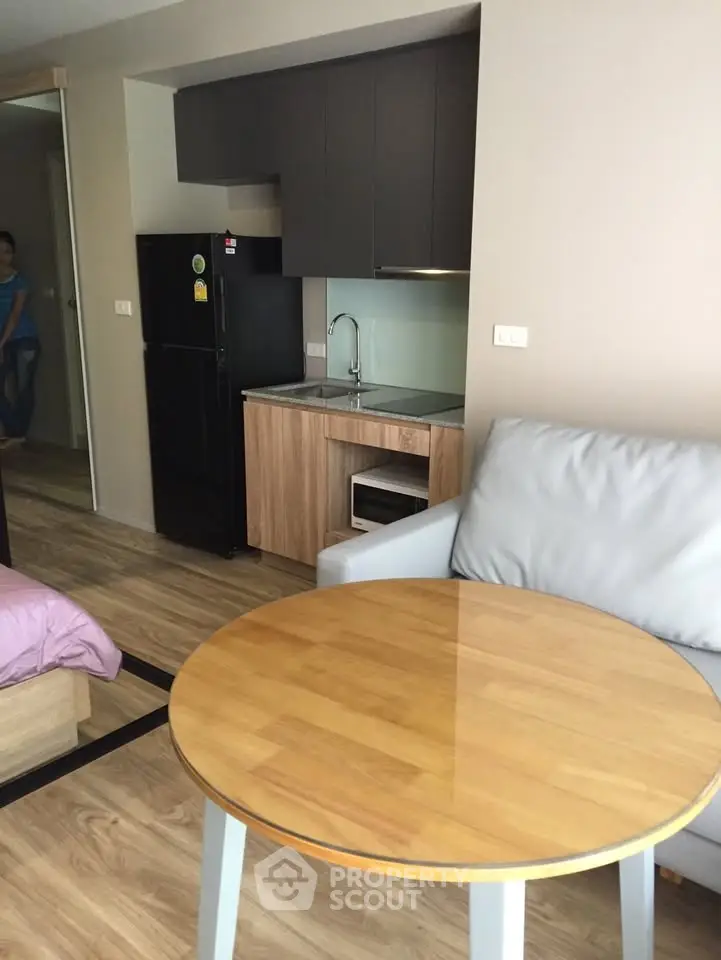 Modern studio apartment with compact kitchen and cozy living area