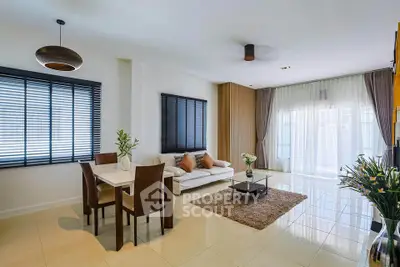 Modern living room with dining area, stylish decor, and natural light