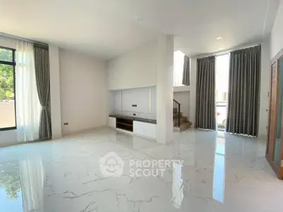 Spacious modern living room with marble flooring and large windows