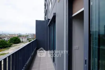 Spacious balcony with city view in modern apartment building