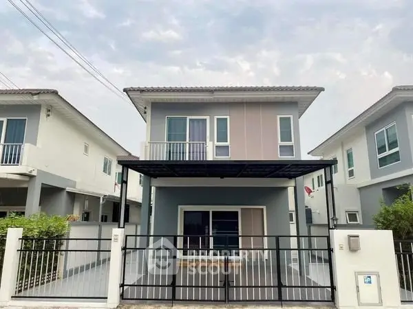 Modern two-story house with sleek design and spacious driveway in suburban neighborhood.