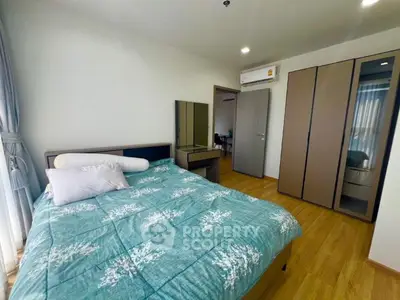 Cozy bedroom with modern furnishings and ample natural light