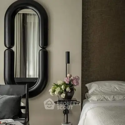 Elegant bedroom with modern decor, featuring a stylish mirror and plush bedding for a luxurious ambiance.