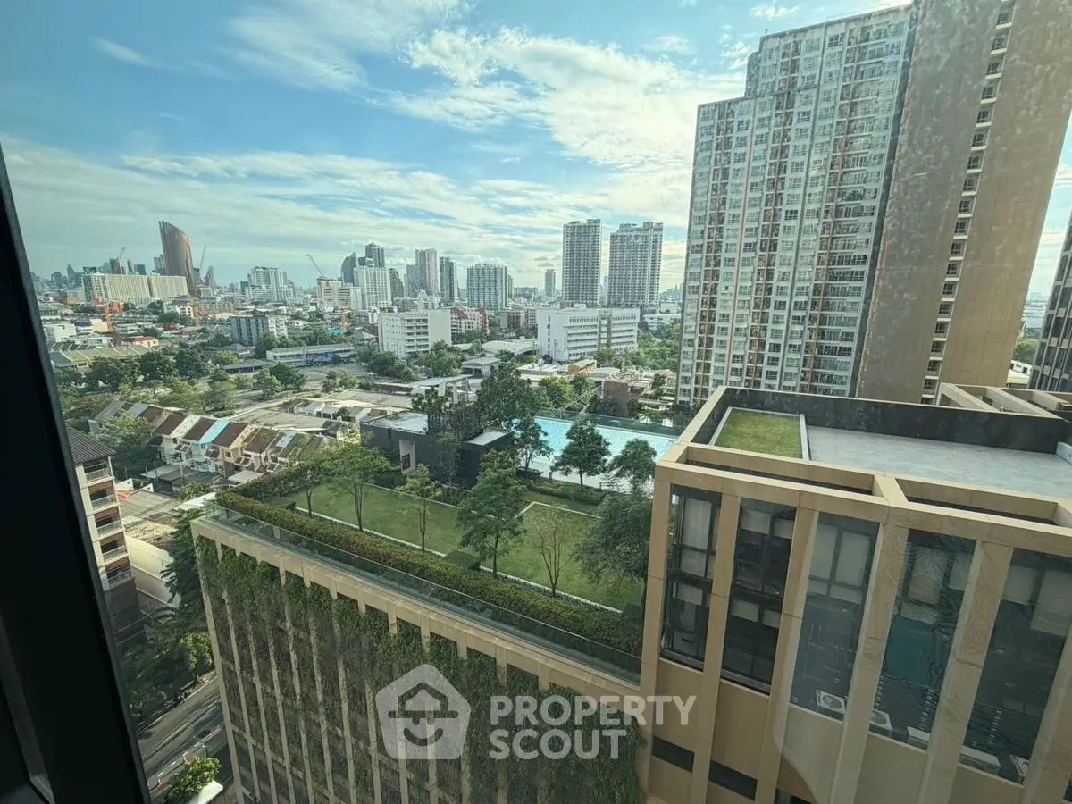 Stunning cityscape view from high-rise building with lush rooftop garden and pool.