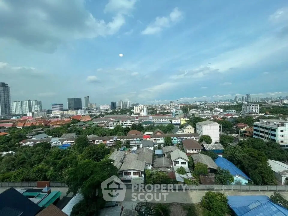 Stunning cityscape view from high-rise building showcasing urban skyline and lush greenery.