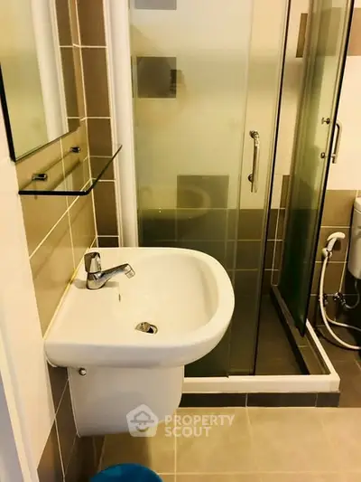 Modern bathroom with sleek sink and glass shower enclosure