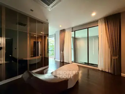Luxurious modern living room with elegant decor and large windows for natural light.