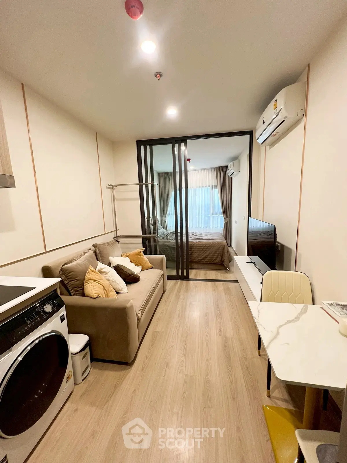 Modern studio apartment with cozy living area and bedroom separation