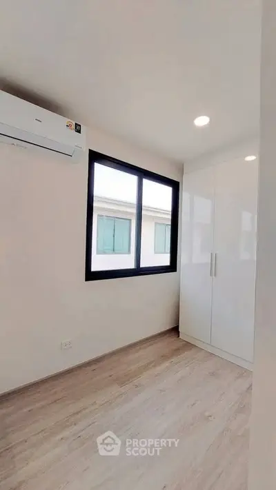 Bright and modern bedroom with air conditioning and sleek wardrobe