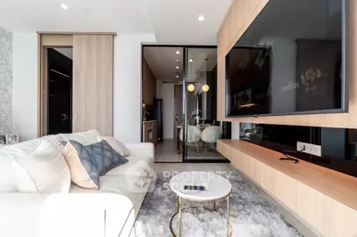 Modern living room with sleek design, large TV, and cozy seating area